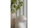 Close-up of a white vase with flowers and a modern sculpture at 312 Meadow Drive Ne, Alpharetta, GA 30009