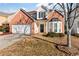 Brick two-story house with attached garage and landscaping at 6469 Alder Ln, Norcross, GA 30093