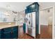 Spacious kitchen with stainless steel refrigerator and teal cabinets at 60 Stonecrest Dr, Dallas, GA 30157