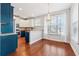 Modern kitchen with granite countertops and teal cabinetry at 60 Stonecrest Dr, Dallas, GA 30157