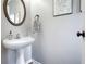 Small powder room with pedestal sink and decorative wall art at 67 Vine Creek Pl, Acworth, GA 30101