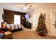 Comfortable bedroom with a Christmas tree and wall-mounted TV at 1024 Riverstone Dr, Social Circle, GA 30025