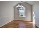 Bright dining room with hardwood floors, large window, and chandelier at 3822 Deercreek Dr, Powder Springs, GA 30127