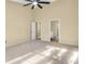 Large bedroom with ceiling fan, carpet, and access to bathroom at 3845 Leprechaun Ct, Decatur, GA 30034