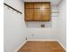 Bright laundry room with wood cabinets and vinyl flooring at 1431 Willow Bend Dr, Snellville, GA 30078