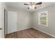 Bedroom with wood floors, ceiling fan, and arched window at 2183 Shillings Chase Nw Dr, Kennesaw, GA 30152