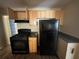 Kitchen features wood cabinets and black appliances at 854 Fayetteville Se Rd, Atlanta, GA 30316