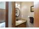 Powder room with granite countertop and round mirror at 4327 Lake Chimney Ne Ct, Roswell, GA 30075