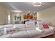 Living room with white sectional sofa, view of kitchen and dining area at 3671 Falconwood Dr, Douglasville, GA 30135