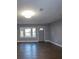 Bright living room with bay window and hardwood floors at 7156 Whitfield Dr, Riverdale, GA 30296