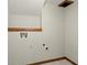 Basement laundry room with built-in shelving and hookups at 755 Wickerberry Knl, Roswell, GA 30075