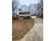 Two-story house with a beige exterior, black shutters, and a driveway at 216 Ridgedale Way, Hoschton, GA 30044