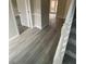 Grey tone laminate flooring and white doors in the hallway at 216 Ridgedale Way, Hoschton, GA 30044