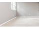 Bright basement room with grey walls and tile floor, featuring a window at 2216 Golden Dawn Sw Dr, Atlanta, GA 30311