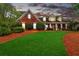 Brick house with front porch, manicured lawn, and pine straw at 328 Broadmoor Way, Mcdonough, GA 30253