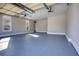 Spacious garage with light gray epoxy flooring and ample storage space at 3166 Sable Ridge Dr, Buford, GA 30519