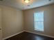 Bright bedroom with dark wood flooring and window blinds at 2725 Dacula Cove Cir, Dacula, GA 30019