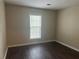 Well-lit bedroom featuring a window with blinds at 2725 Dacula Cove Cir, Dacula, GA 30019