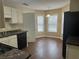 Kitchen with white cabinets, black appliances, and granite countertops at 2725 Dacula Cove Cir, Dacula, GA 30019