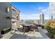 Spacious rooftop terrace with fireplace, city views, and dining furniture at 3630 Peachtree Ne Rd # 2207, Atlanta, GA 30326