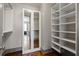 Large walk-in closet with built-in shelving and mirrored doors at 3630 Peachtree Ne Rd # 2207, Atlanta, GA 30326