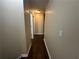 Long hallway with dark brown wood-look flooring at 855 Scenic Lake Dr, Lawrenceville, GA 30045