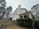 House side view with wooden fence and landscaping at 855 Scenic Lake Dr, Lawrenceville, GA 30045