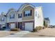 Two-story townhome with attached garage, brick accents, and siding at 127 Meeting Place Rd, Lawrenceville, GA 30044