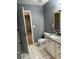 Bathroom with granite vanity, white tile floor and gray walls at 6506 S Gordon Rd, Austell, GA 30168