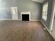 Living room with fireplace, hardwood floors, and large windows at 6506 S Gordon Rd, Austell, GA 30168