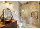 Elegant bathroom with glass shower, antique vanity, and updated fixtures at 230 Edwards Brook Ct, Canton, GA 30115