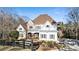 House exterior showcasing a light-colored home with a metal roof and stone accents at 230 Edwards Brook Ct, Canton, GA 30115