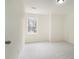 Simple bedroom with window and neutral walls at 7011 Overlook Pt, Stone Mountain, GA 30087