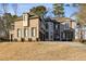 Brick two-story house with a three-car garage and landscaped lawn at 4159 Gemstone Ter, Marietta, GA 30062