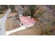 House with red metal roof and a long driveway, aerial view at 70 E Honeysuckle Ln, Carrollton, GA 30116