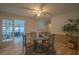 Dining room with glass table, four chairs, and access to sunroom at 70 E Honeysuckle Ln, Carrollton, GA 30116