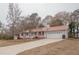 Gray house with red metal roof, shutters, and a long driveway at 70 E Honeysuckle Ln, Carrollton, GA 30116