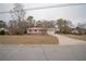 Ranch home with red metal roof, attached garage, and spacious yard at 70 E Honeysuckle Ln, Carrollton, GA 30116