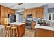 Modern kitchen with light wood cabinets, quartz countertops, and island at 1035 Bridle Path Dr, Lawrenceville, GA 30045