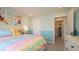 Cute bedroom with rainbow bedding and access to bath at 146 Oakchase Park Ln, Hampton, GA 30228