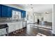 Bright kitchen with blue cabinets, granite counters, and stainless steel appliances at 301 Ashbourne Trl, Lawrenceville, GA 30043