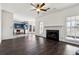 Open living room with fireplace, kitchen view, and hardwood floors at 301 Ashbourne Trl, Lawrenceville, GA 30043