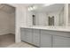 Modern bathroom with double vanity, grey cabinets, and a large mirror at 2065 Morrison Ave, Brookhaven, GA 30319
