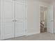 Well-lit bedroom with double doors leading to the hallway at 2065 Morrison Ave, Brookhaven, GA 30319