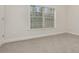 Bright bedroom with neutral carpeting and large window at 2065 Morrison Ave, Brookhaven, GA 30319