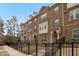 Townhouses with stone and brick exteriors and black fences at 2065 Morrison Ave, Brookhaven, GA 30319