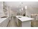 Open concept kitchen with island, stainless steel appliances, and gray cabinets at 2065 Morrison Ave, Brookhaven, GA 30319