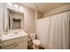 Clean bathroom with white vanity, toilet, and shower at 717 Woodstock Grove Dr, Woodstock, GA 30188