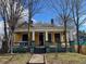Yellow house with wrap-around porch and mature trees at 1786 Lakewood Ave, Atlanta, GA 30315