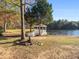 Peaceful lakeside gazebo with white lattice and walkway at 427 W Mcintosh W Rd, Brooks, GA 30205